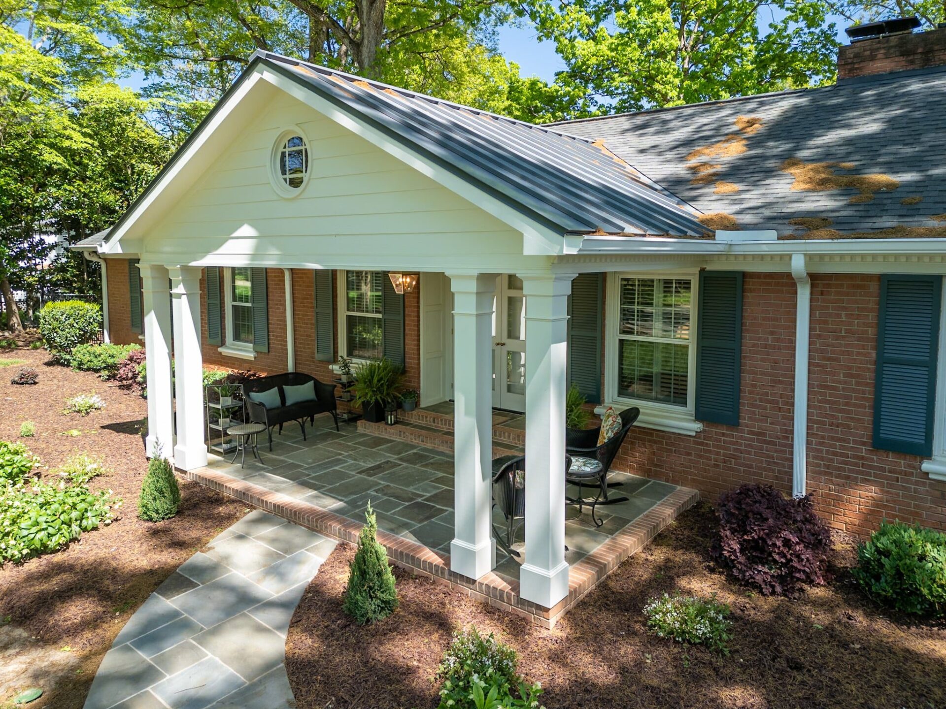 White gabled portico, flagstone patio, and curved walkway, custom built by Carolina Decks in the Charlotte, NC area.