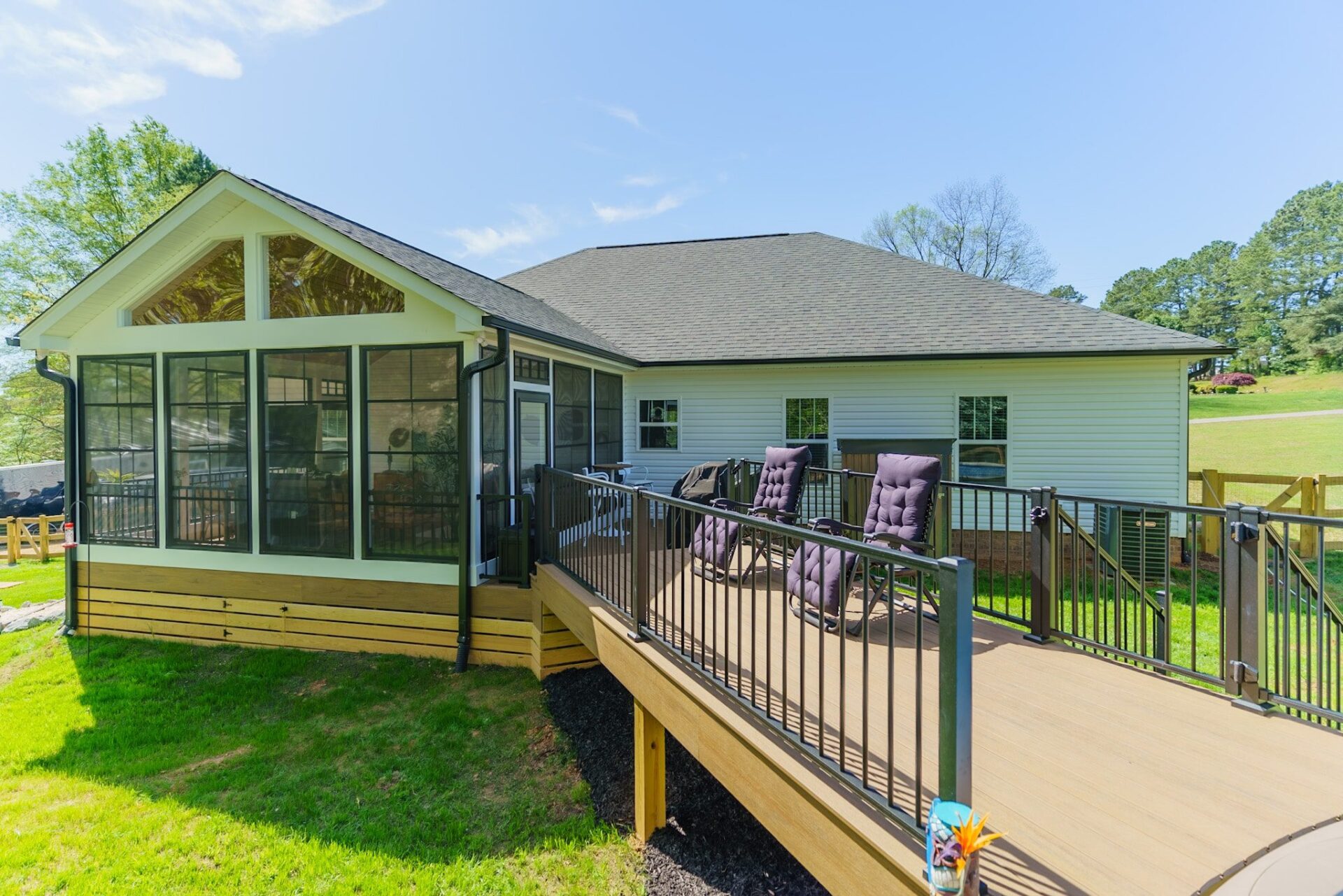 Gable screened porch and composite deck with metal railings and ramp access, custom built by Carolina Decks in Kannapolis.