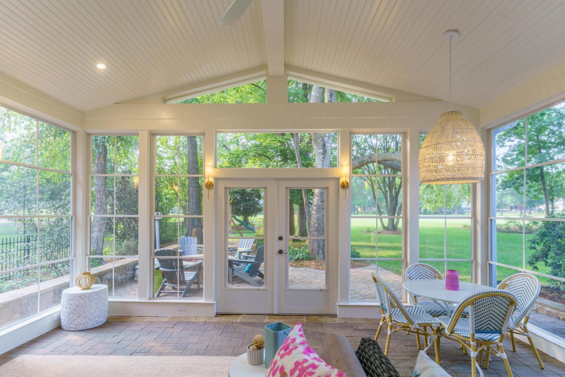 Screened porch with vaulted beadboard ceiling and brick paver floor, custom built by Carolina Decks in the Charlotte, NC area.