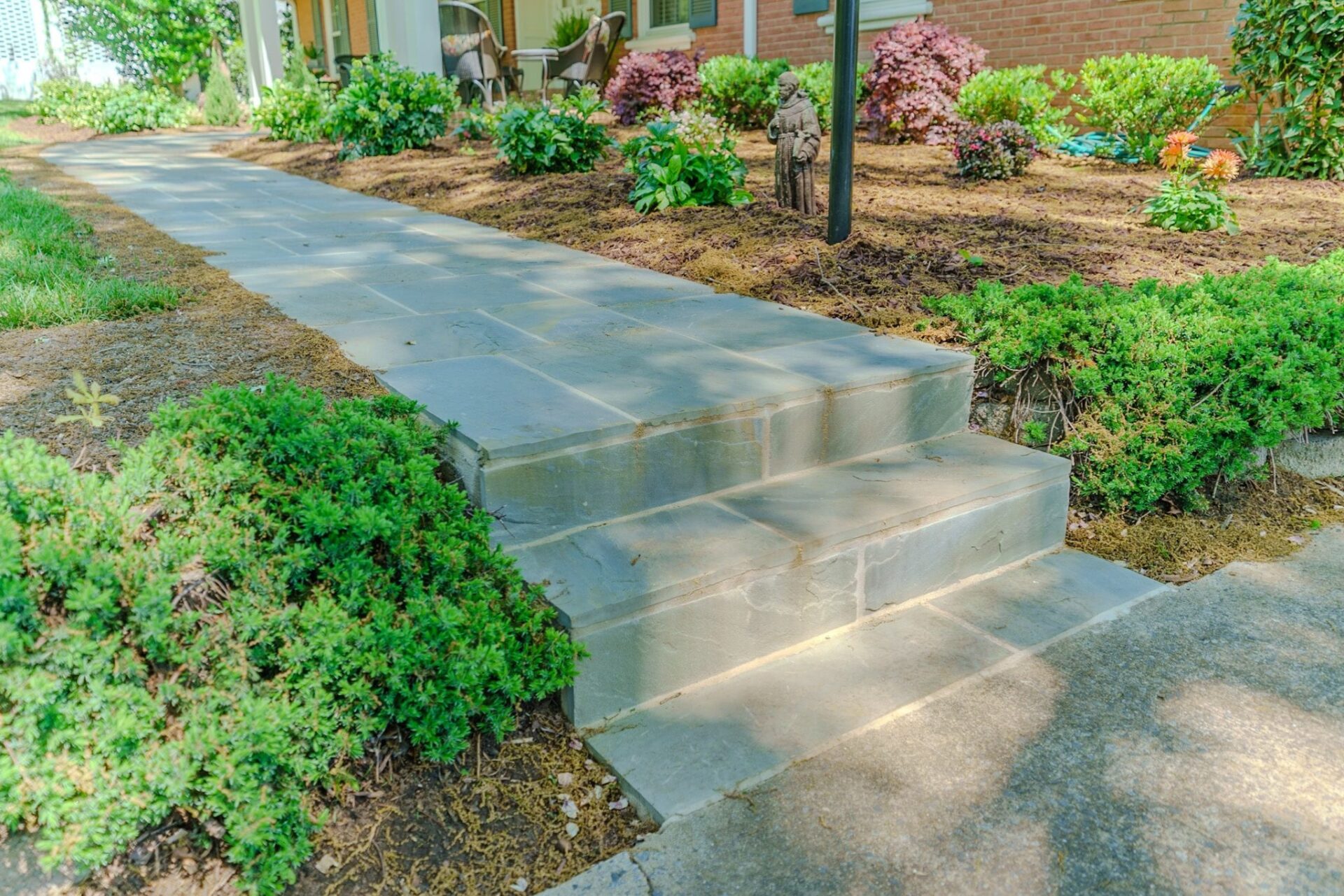 Bluestone paver walkway and two steps from concrete to yard, custom built by Carolina Decks in the Charlotte, NC area.