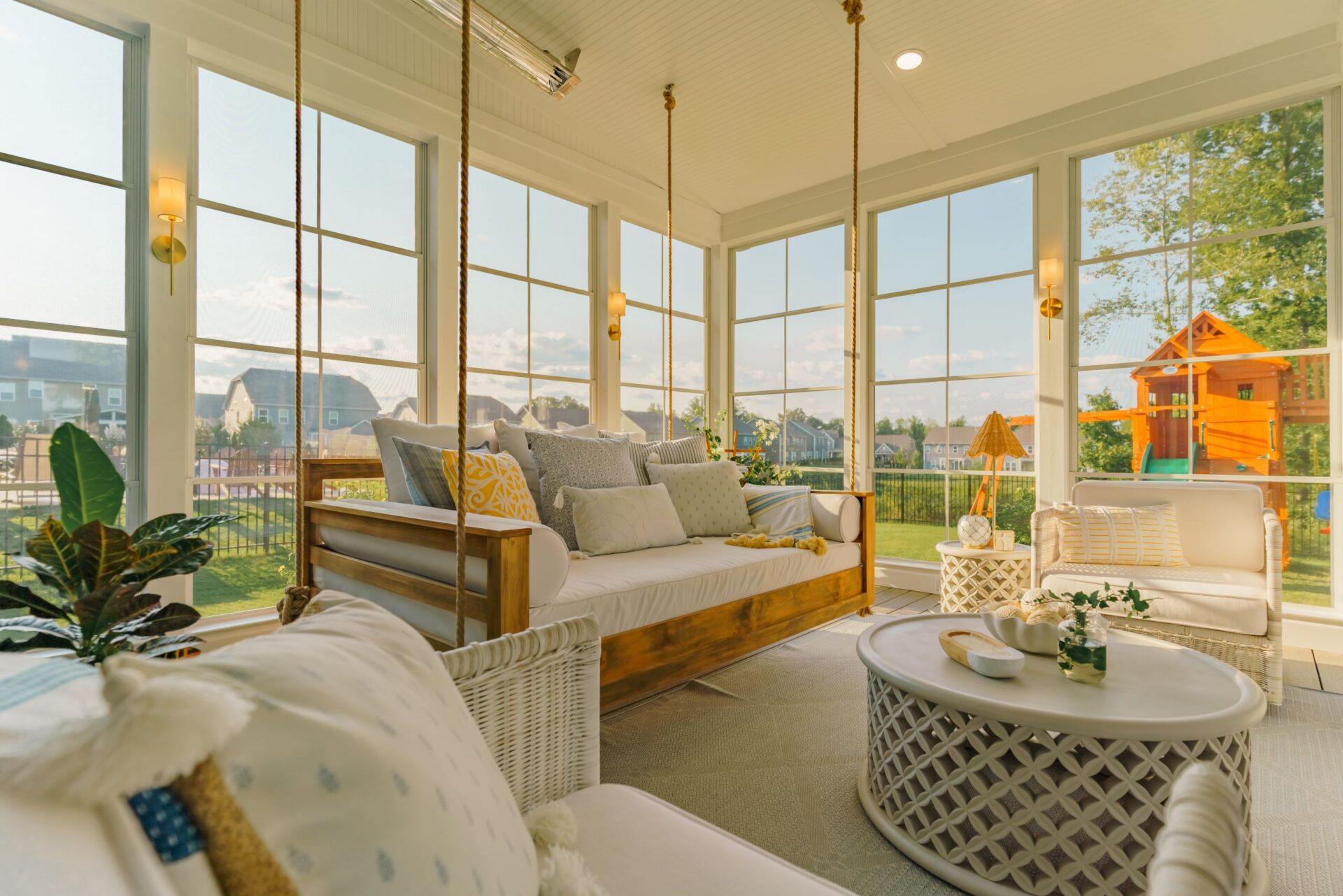 Sunroom with beadboard ceiling and suspended daybed, custom built by Carolina Decks in the Huntersville, NC area.