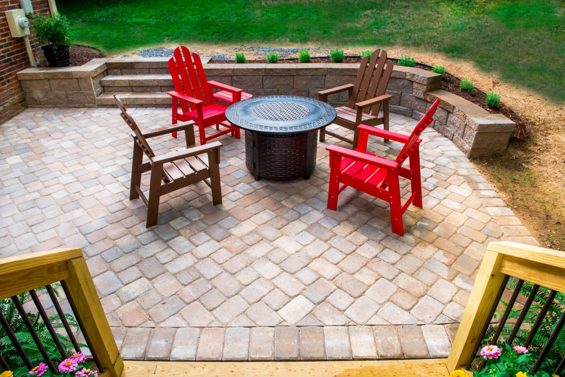 Beautiful multi-toned paver patio with tiered retaining walls and steps, custom built by Carolina Decks in the Charlotte, NC area.