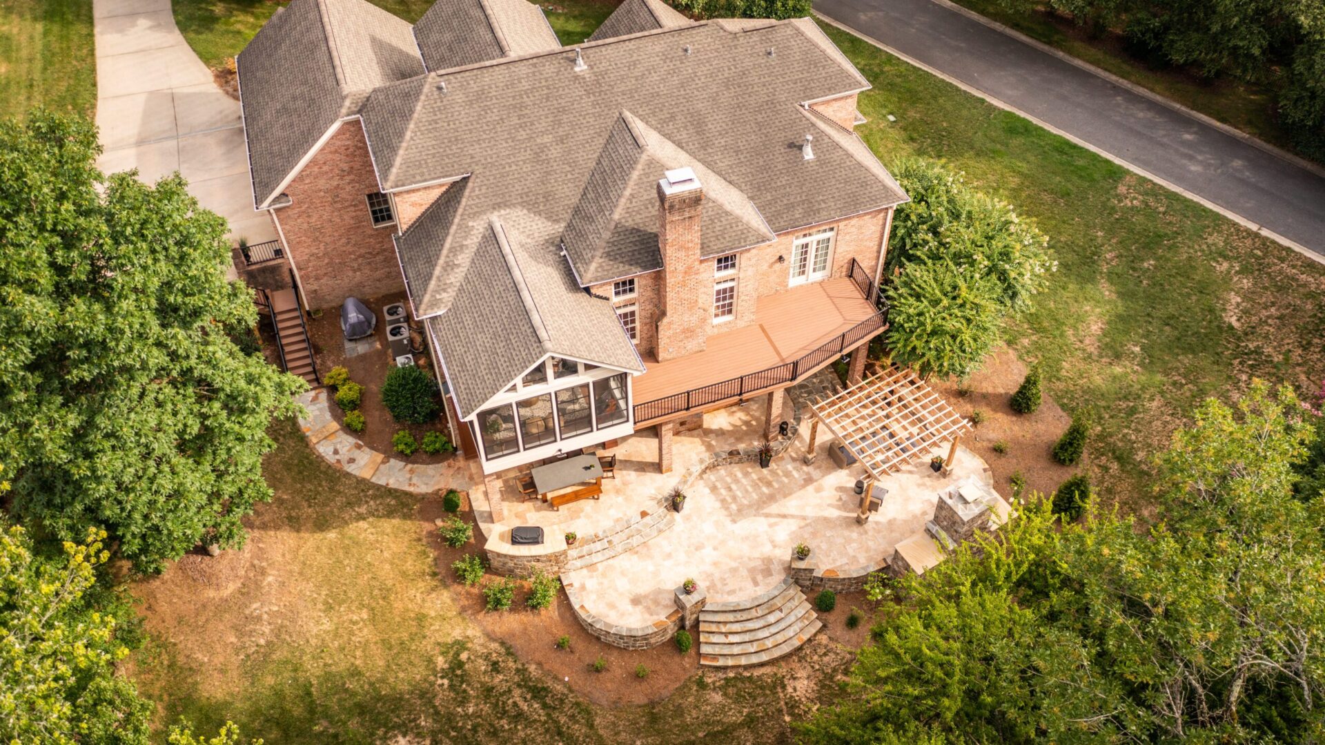 Paver patio, wood pergola, composite deck, and screened porch custom built by Carolina Decks in the Waxhaw area.