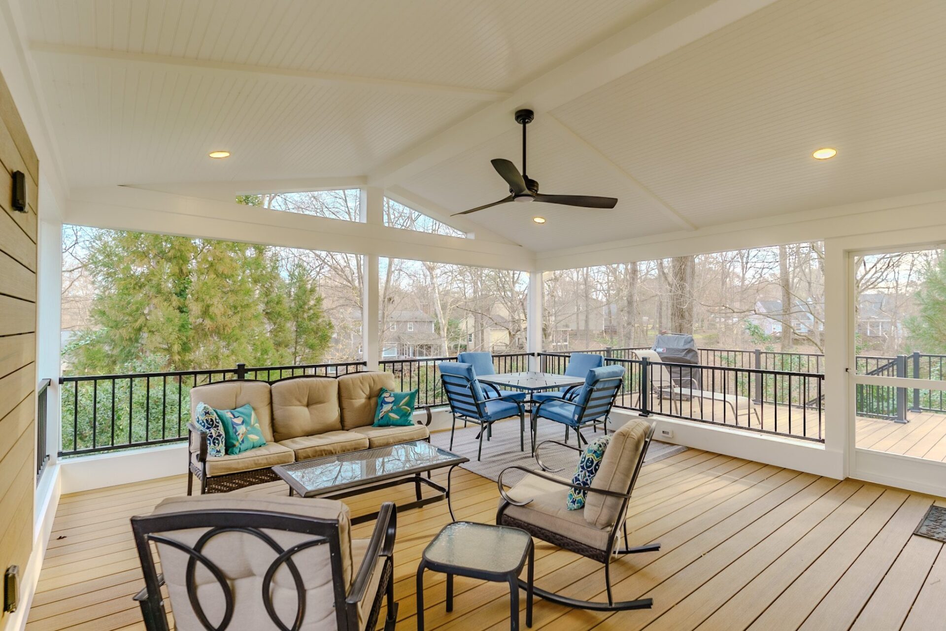 Spacious covered composite deck, vaulted beadboard ceiling, black railing, recessed lighting, custom built by Carolina Decks in the Weddington neighborhood.