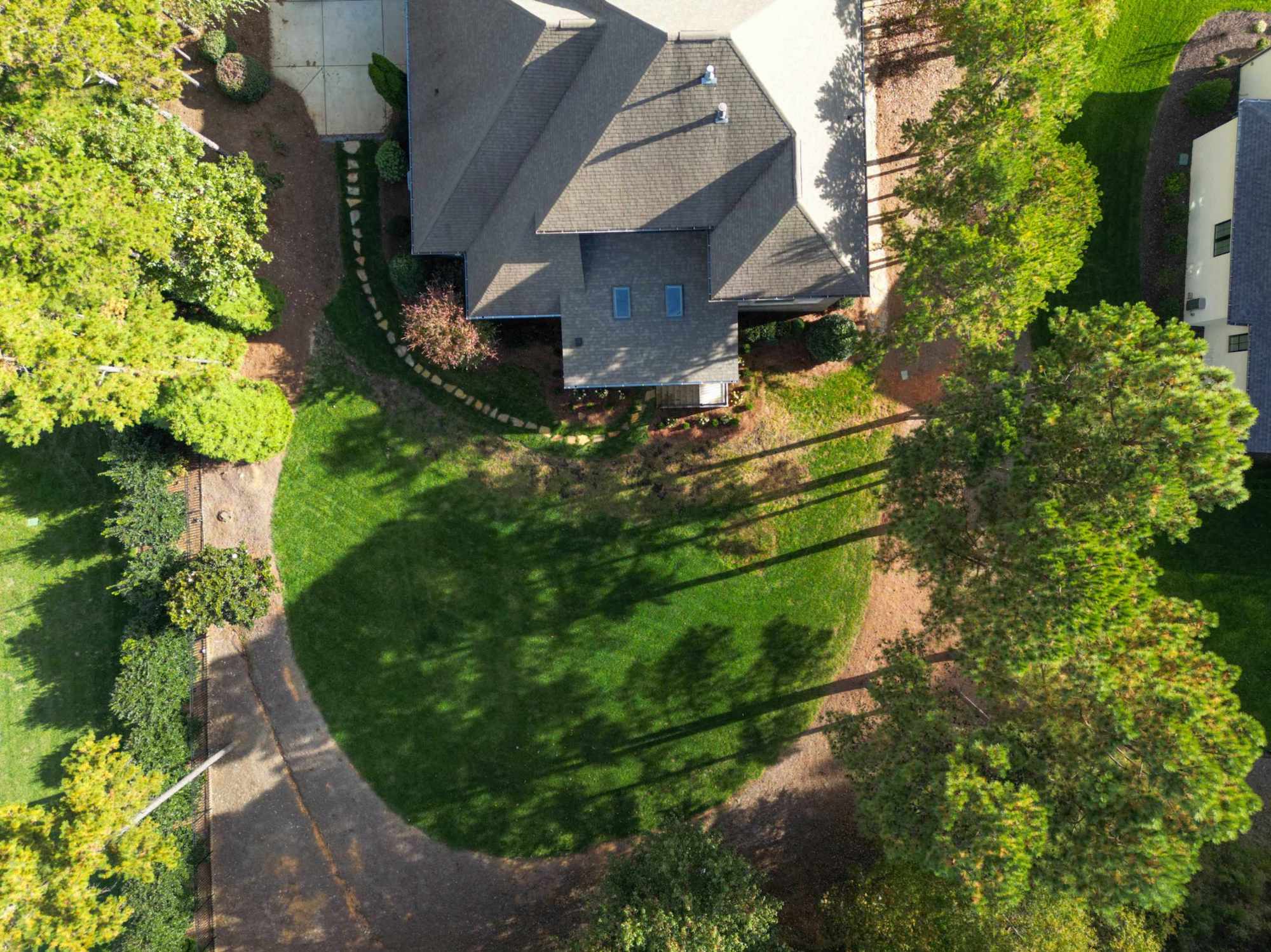 Custom winding stone garden path through lush landscaping, custom built by Carolina Decks in the Charlotte, NC area.