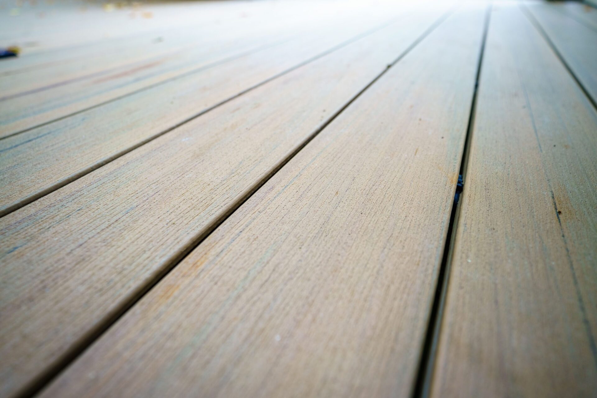 Detailed view of a durable, light composite deck surface with subtle wood grain texture, custom built by Carolina Decks in the Charlotte, NC area.