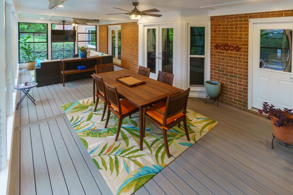 Spacious screened porch with gray composite decking, white ceiling, and large windows, custom built by Carolina Decks in the South Charlotte, NC area.