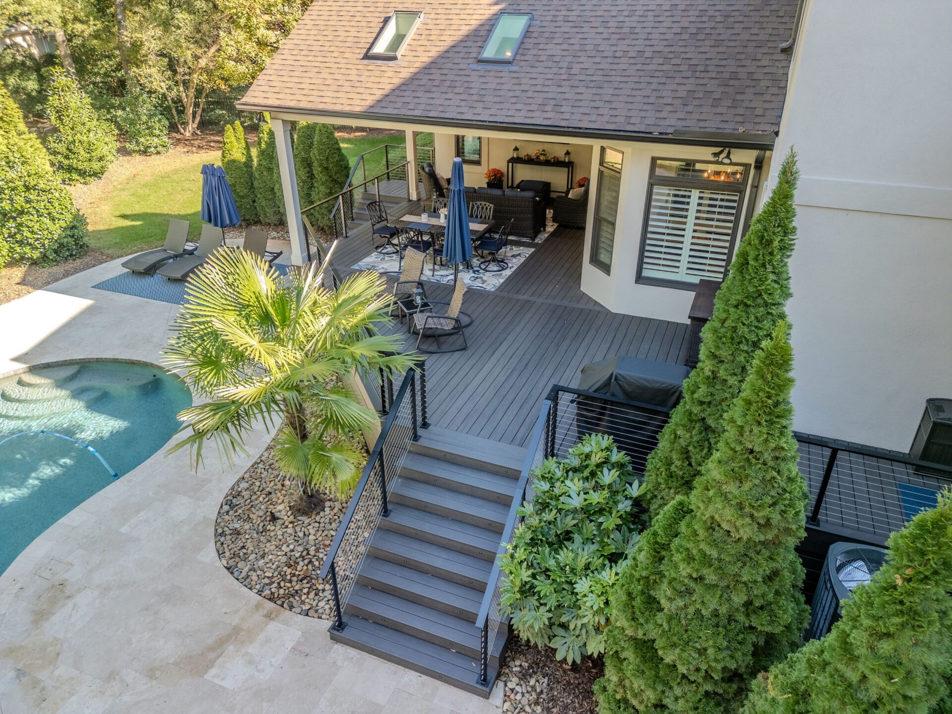 Composite deck, cable railing, covered patio and pool, custom built by Carolina Decks in the Charlotte, NC area.