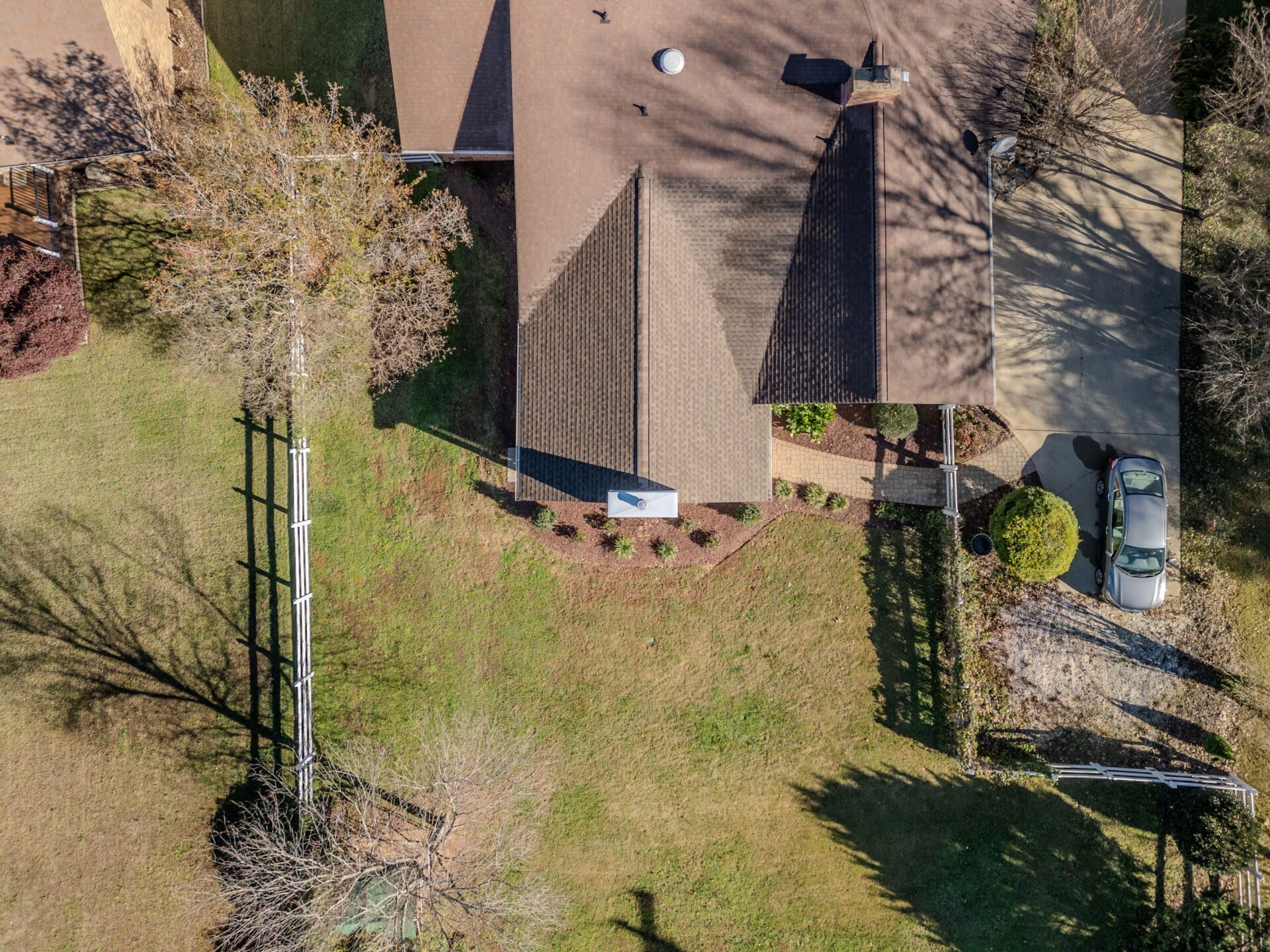 Aerial view of a home with a straight paver walkway and neat landscaping, custom built by Carolina Decks in the Charlotte, NC area.
