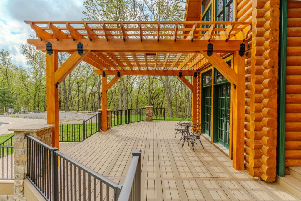Timber pergola and light composite deck with black railings, custom built by Carolina Decks in the Charlotte, NC area.