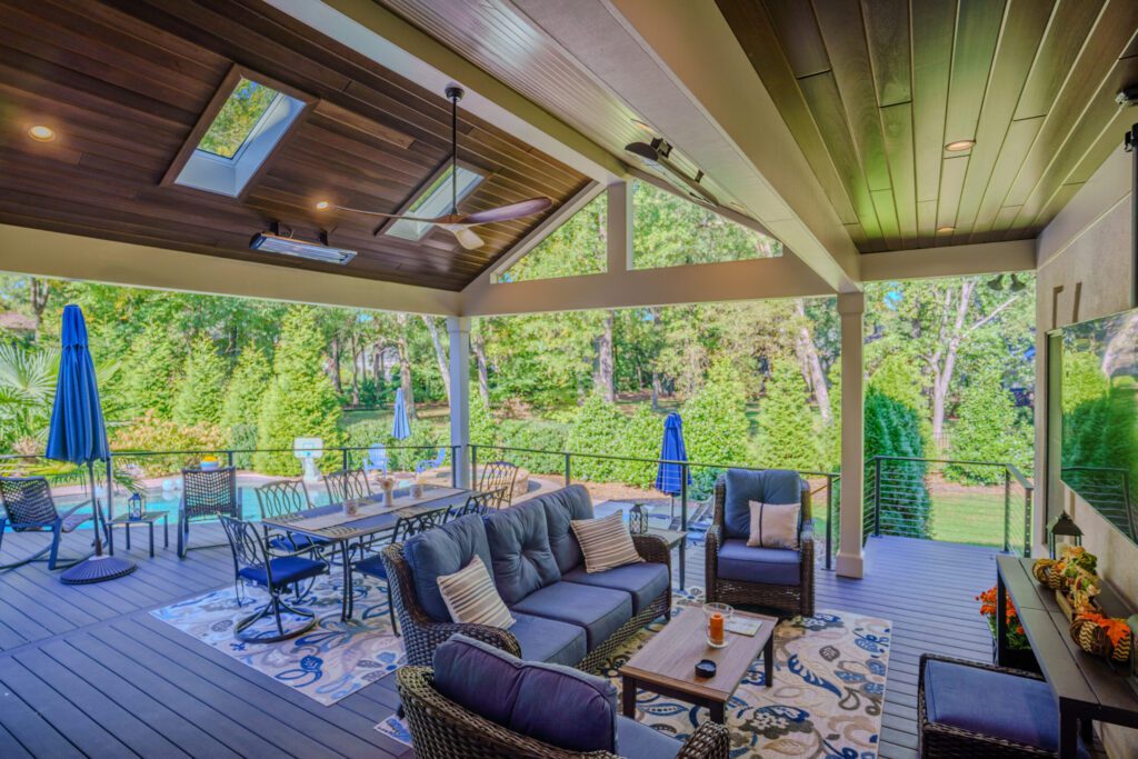 Covered composite deck with wood ceiling, skylights, and cable railing, custom built by Carolina Decks in the Charlotte, NC area.