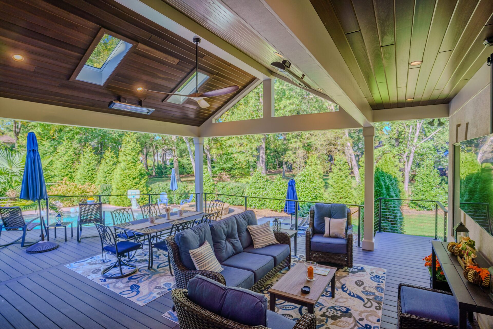 Covered composite deck with wood ceiling, skylights, and cable railing, custom built by Carolina Decks in the Charlotte, NC area.
