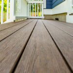 Detailed brown textured composite decking boards and clean white railings, custom built by Carolina Decks in the Charlotte, NC area.