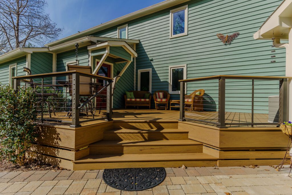 Multi-level composite deck with modern cable railing and paver patio, custom built by Carolina Decks in the Belmont, NC area.