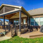 Spacious multi-level composite deck with black railings and a vaulted screened porch with wood ceiling, custom built by Carolina Decks in the Skybrooke neighborhood.