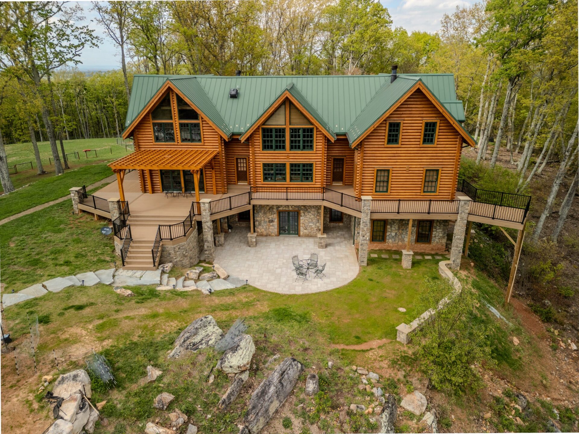 A multi-level outdoor living addition featuring a TimberTech pergola and Trex railings built for a Lake Norman home.