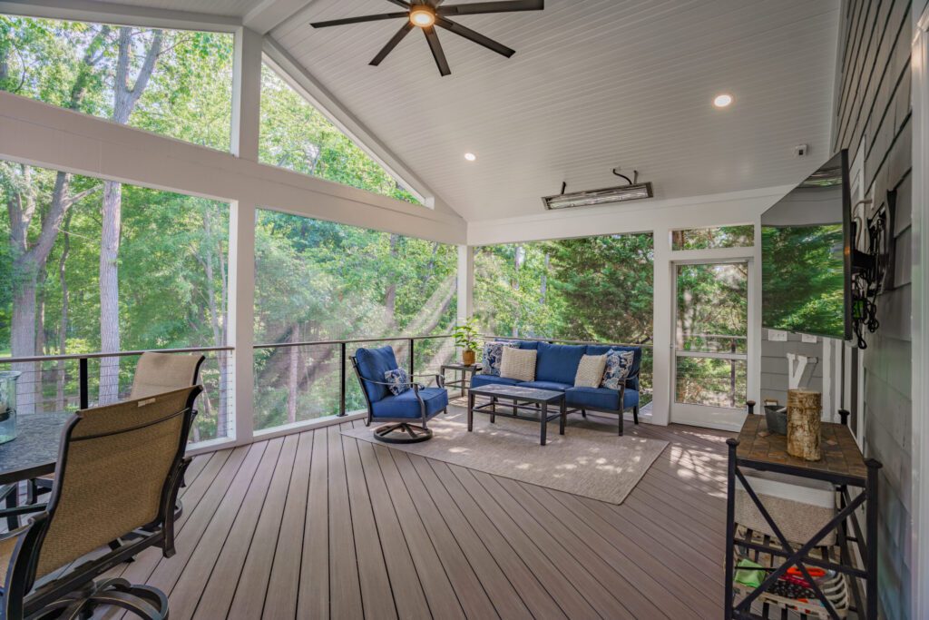 Interior of a screened porch with vaulted ceilings and heaters overlooking Lake Norman.