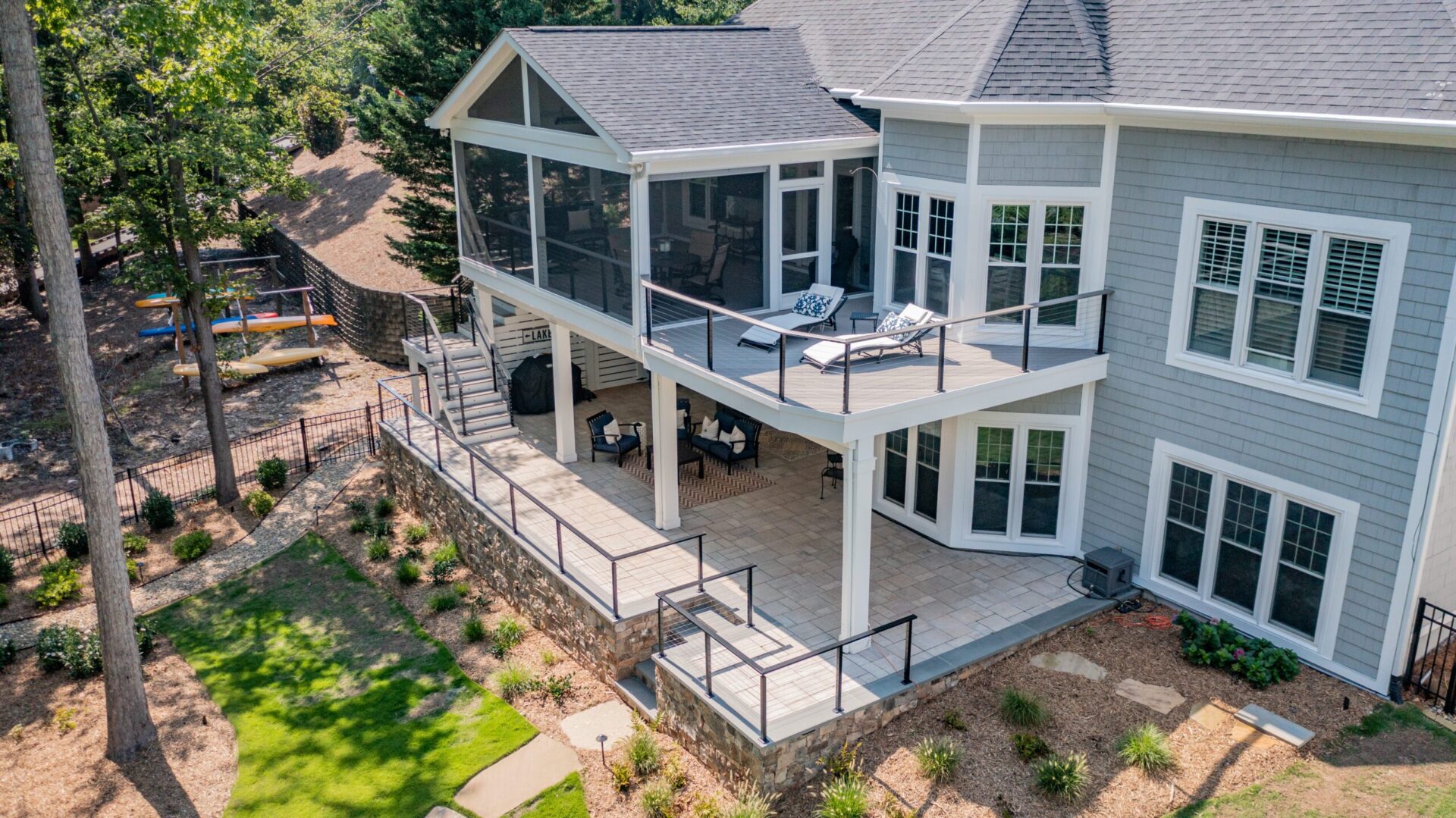 Aerial view of a custom multi-level deck and stone patio by Carolina Decks on Lake Norman.