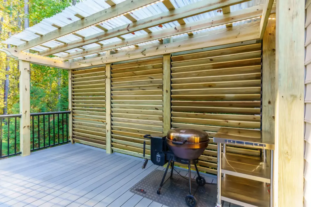 A luxury covered deck in Mt Isle Harbor featuring a custom roof extension over TimberTech Sea Salt Grey decking and Trex aluminum railings.