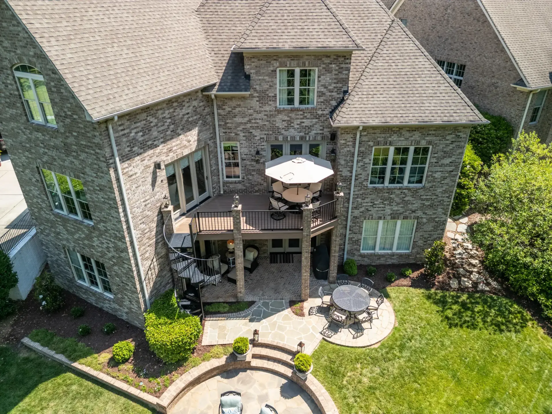 Elevated drone view of a completed deck resurface project in Wessex Square, South Charlotte, featuring TimberTech Black Walnut composite decking and a black Trex aluminum railing.