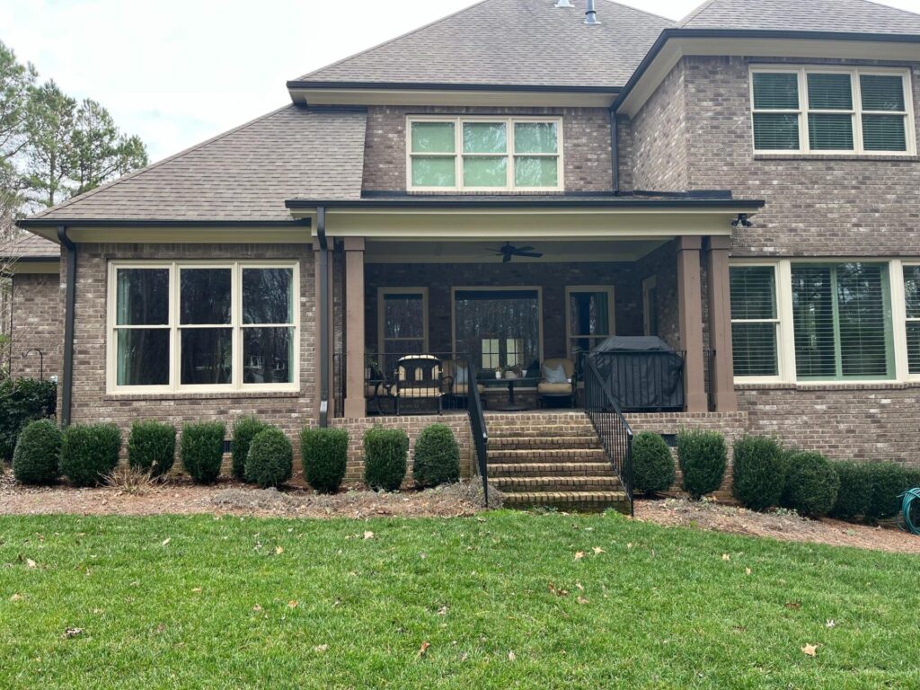 Rear view of Mint Hill home prior to adding a luxury stone outdoor kitchen and expanded covered porch outdoor living space.