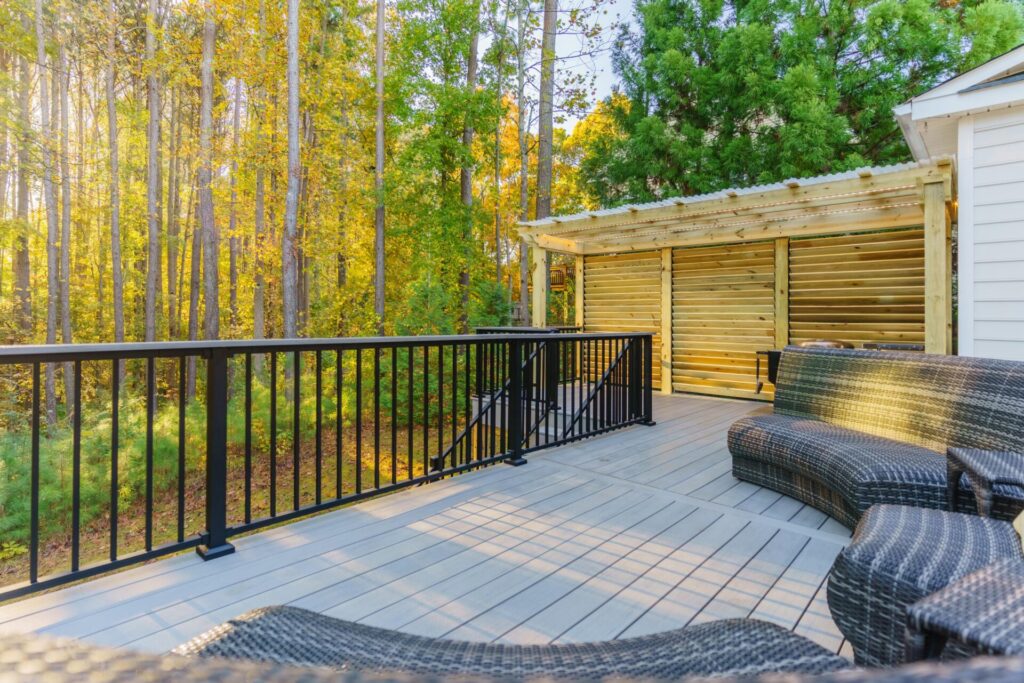 Elevated deck in Mt Isle Harbor with TimberTech Sea Salt Gray composite decking, Trex black aluminum railing, and a matching pergola with privacy walls.