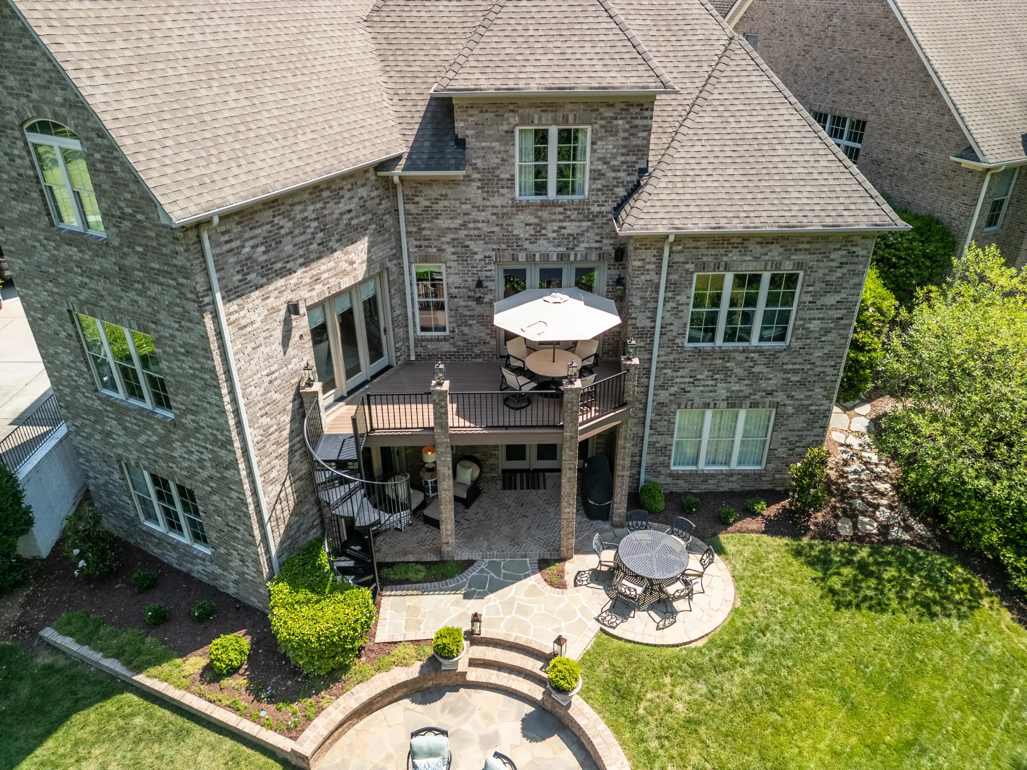 Elevated drone view of a completed deck resurface project in Wessex Square, South Charlotte, featuring TimberTech Black Walnut composite decking and a black Trex aluminum railing.
